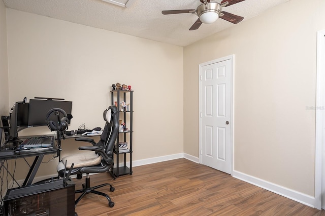 office area featuring ceiling fan, wood-type flooring, and a textured ceiling