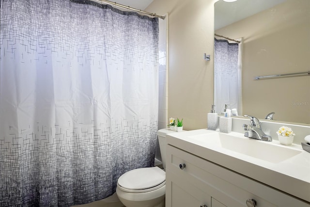 full bathroom featuring vanity, shower / tub combo, and toilet