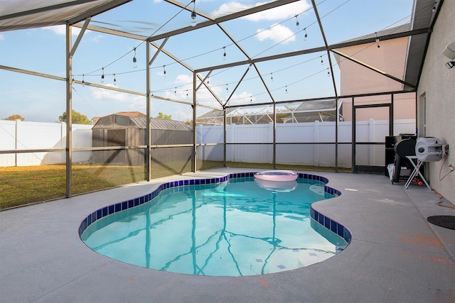 view of swimming pool featuring a yard, a patio, and a lanai