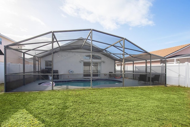 view of swimming pool featuring a lanai, a patio area, and a lawn