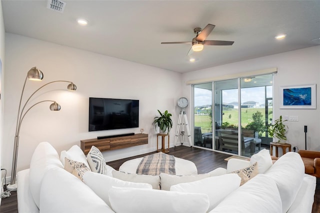 living room with ceiling fan and dark wood-type flooring