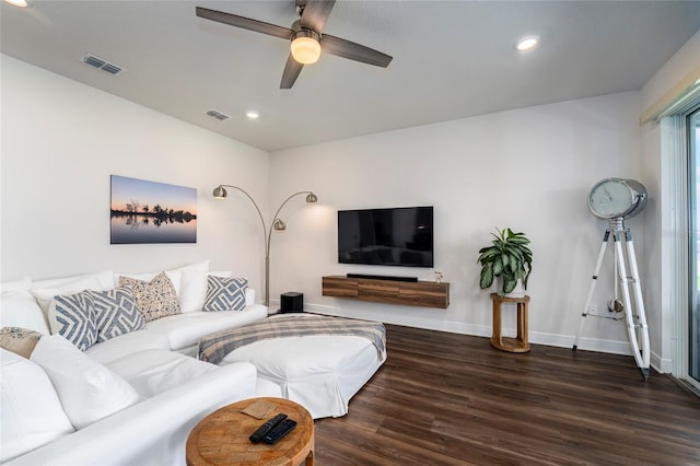 living room with ceiling fan and dark wood-type flooring