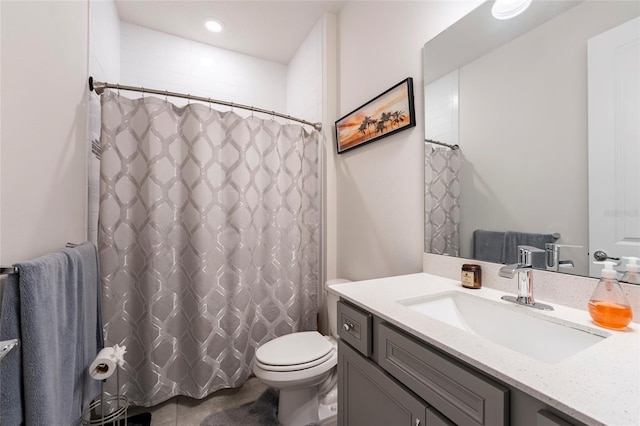 bathroom with vanity, toilet, and curtained shower