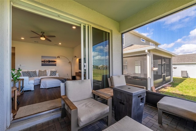 sunroom featuring ceiling fan