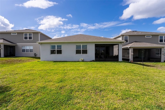 back of property featuring a yard and a sunroom