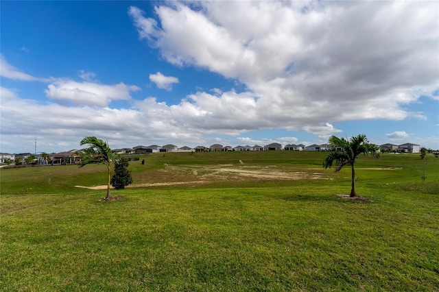 view of property's community featuring a yard