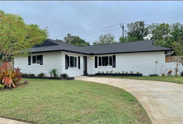 ranch-style home with a front yard