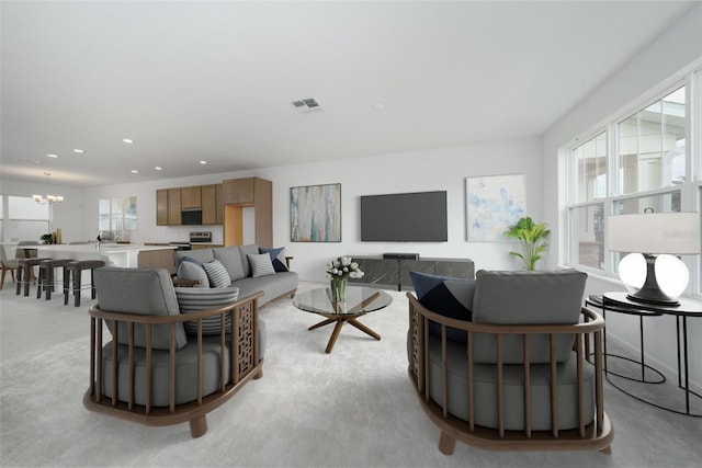 living room with a wealth of natural light and an inviting chandelier