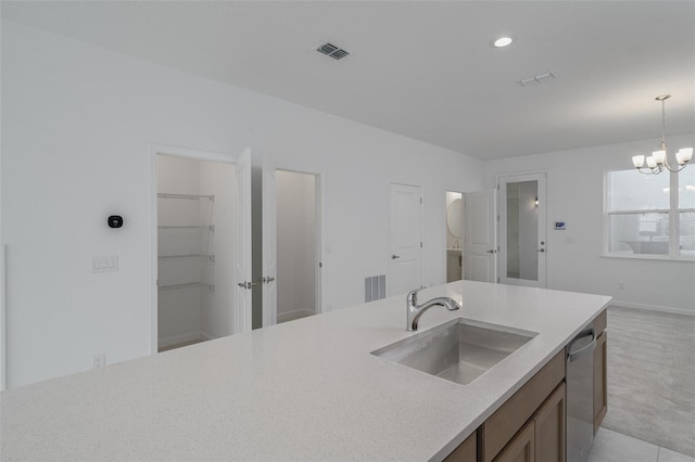 kitchen featuring sink, an inviting chandelier, stainless steel dishwasher, decorative light fixtures, and light carpet