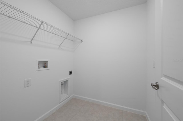 clothes washing area featuring electric dryer hookup, hookup for a washing machine, and light tile patterned flooring