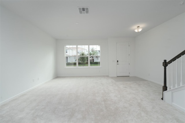 unfurnished living room with light carpet