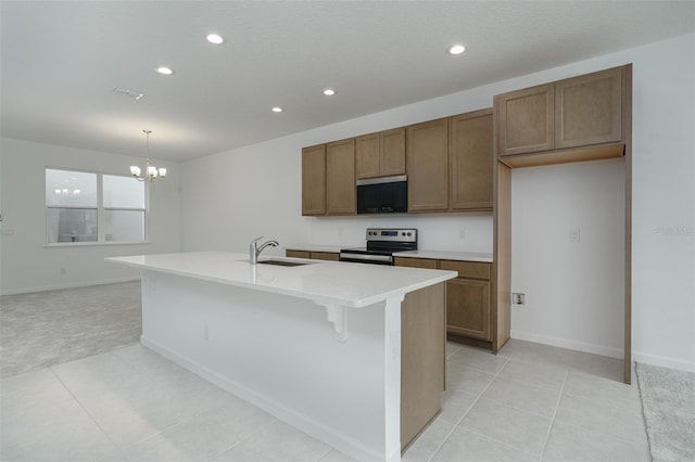 kitchen with sink, a chandelier, decorative light fixtures, a center island with sink, and appliances with stainless steel finishes