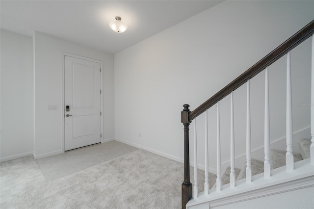 foyer entrance with light carpet