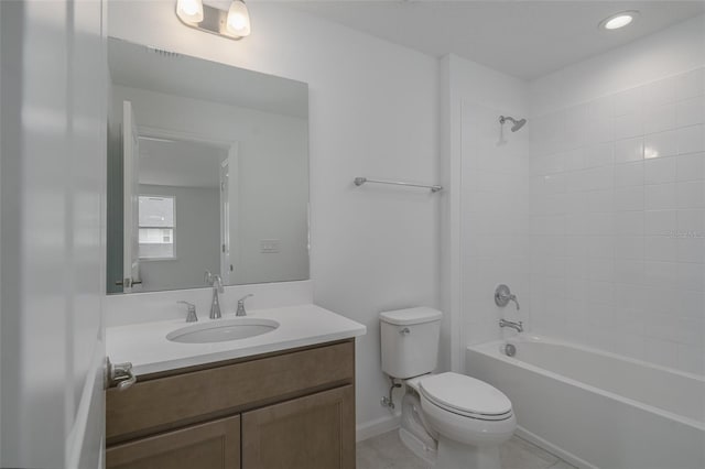 full bathroom with tile patterned flooring, vanity, tiled shower / bath combo, and toilet