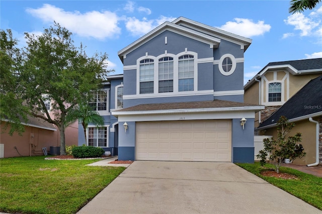 view of front property featuring central AC, a garage, and a front lawn