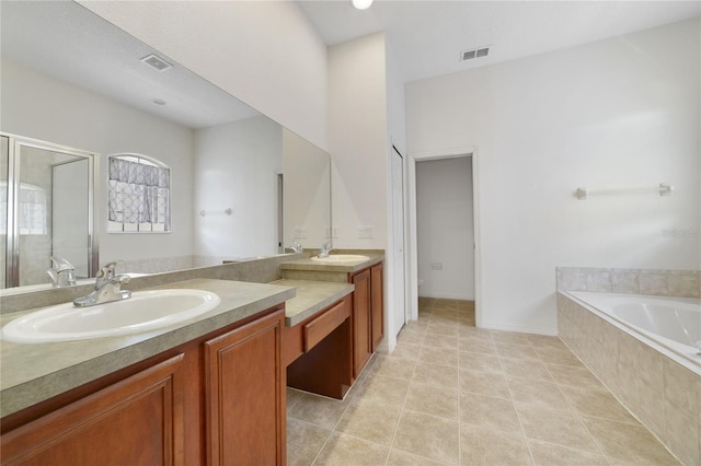 full bathroom featuring tile patterned flooring, vanity, shower with separate bathtub, and toilet