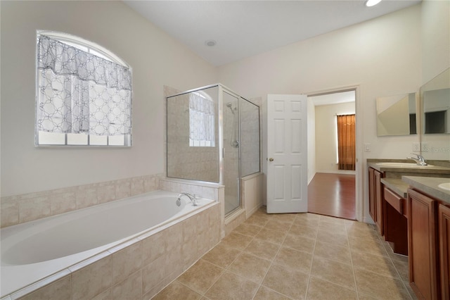 bathroom featuring tile patterned floors, vanity, and shower with separate bathtub