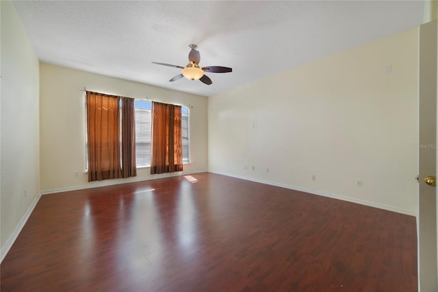 spare room with ceiling fan, dark hardwood / wood-style flooring, and a textured ceiling