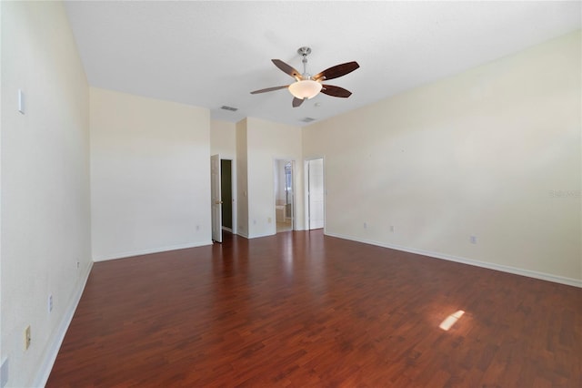 empty room featuring ceiling fan and dark hardwood / wood-style flooring