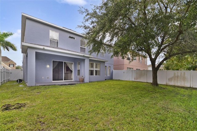 rear view of house with a lawn