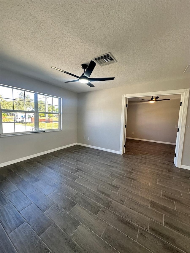 unfurnished bedroom featuring ceiling fan, dark hardwood / wood-style flooring, and a textured ceiling