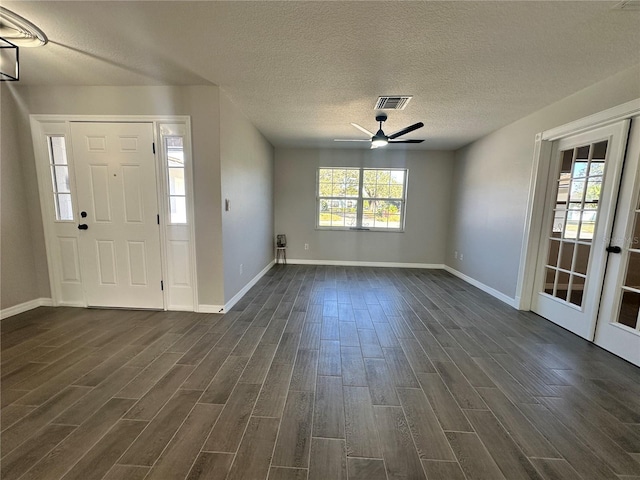 foyer featuring ceiling fan, dark hardwood / wood-style flooring, and a textured ceiling