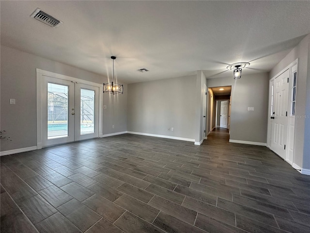 spare room featuring dark hardwood / wood-style floors and french doors