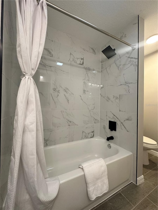 bathroom with tile patterned floors, a textured ceiling, toilet, and shower / bath combo with shower curtain