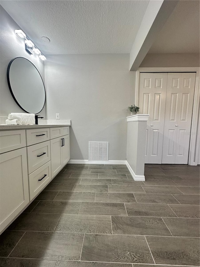 bathroom featuring vanity and a textured ceiling