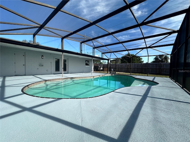 view of swimming pool with a patio and a lanai