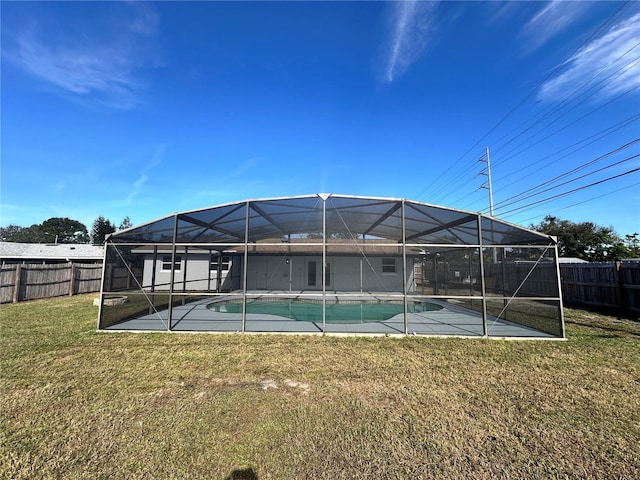 exterior space with a lawn and glass enclosure