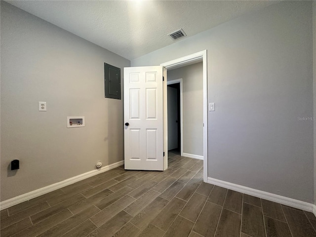 laundry room with dark hardwood / wood-style floors, electric panel, a textured ceiling, and hookup for a washing machine