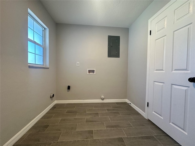 washroom featuring electric panel, dark hardwood / wood-style flooring, a textured ceiling, and hookup for a washing machine