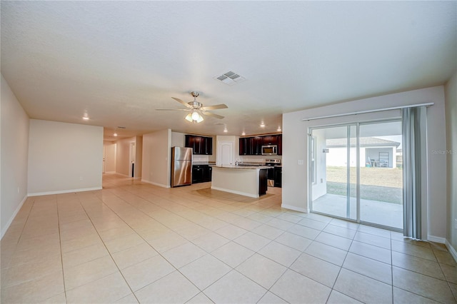 unfurnished living room with ceiling fan and light tile patterned flooring