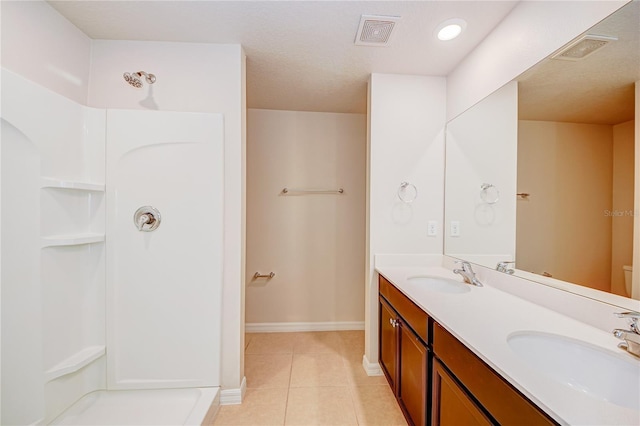 bathroom featuring toilet, tile patterned floors, and vanity