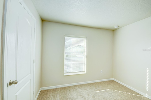 empty room featuring light carpet