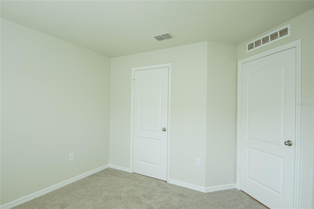 unfurnished bedroom with light carpet