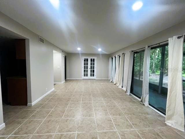 tiled spare room with french doors