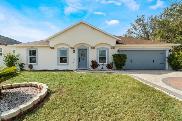 ranch-style house with a garage and a front lawn