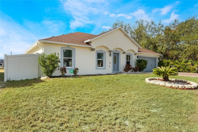 mediterranean / spanish-style home featuring a garage and a front lawn