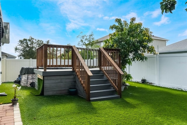 rear view of property featuring a deck and a lawn