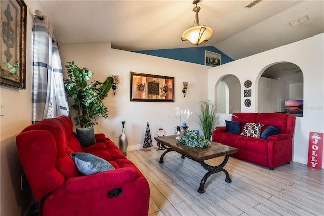 living room with light hardwood / wood-style flooring and lofted ceiling