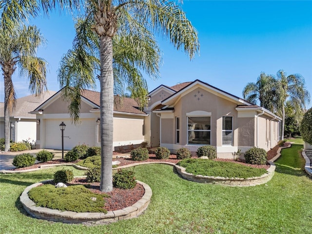 ranch-style home featuring a garage and a front lawn