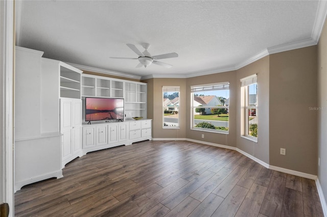 unfurnished living room featuring a textured ceiling, dark wood-type flooring, and a wealth of natural light