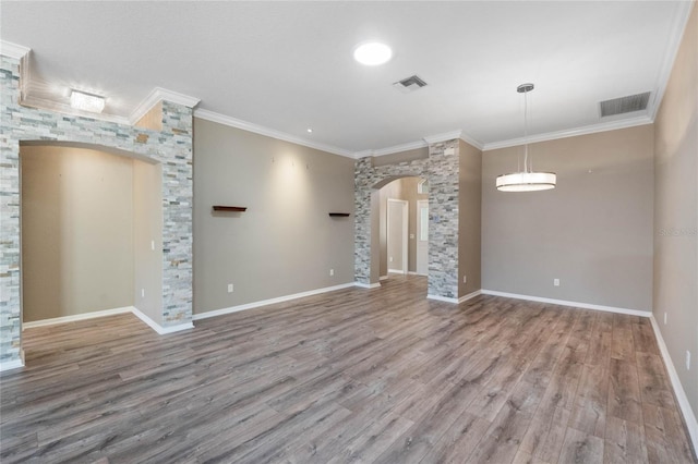 unfurnished living room featuring wood-type flooring and crown molding