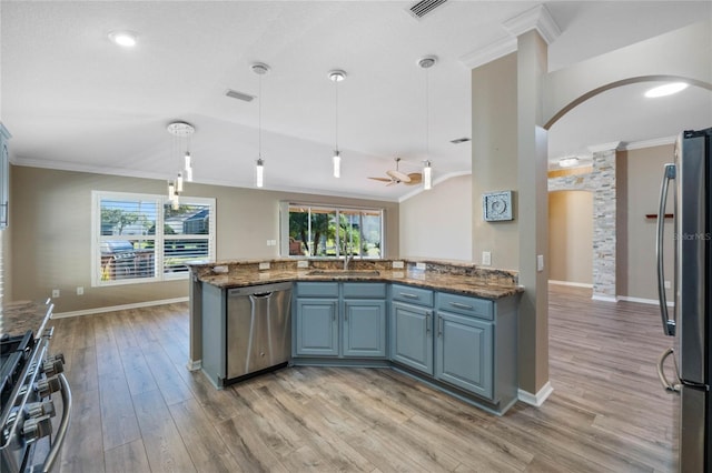 kitchen with light hardwood / wood-style floors, kitchen peninsula, pendant lighting, and appliances with stainless steel finishes