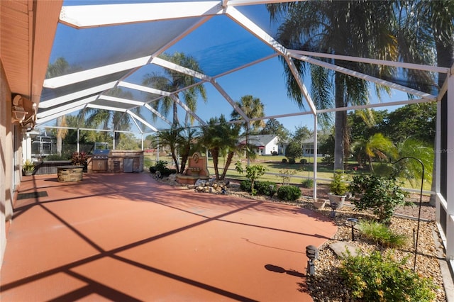 view of patio featuring area for grilling and a lanai