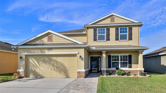 view of front of house featuring a garage and a front yard