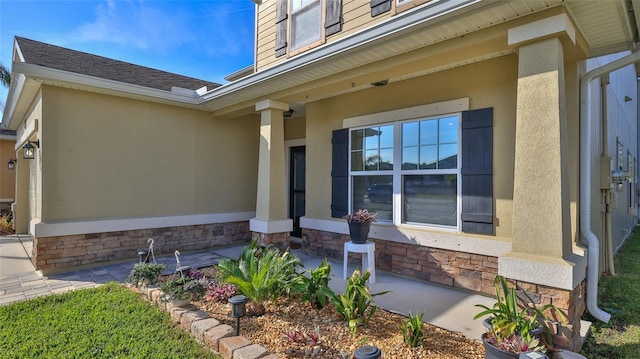 view of exterior entry with a porch