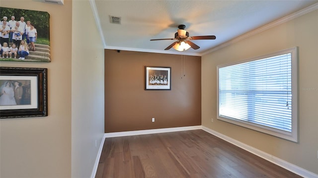 spare room featuring ceiling fan, crown molding, and wood-type flooring